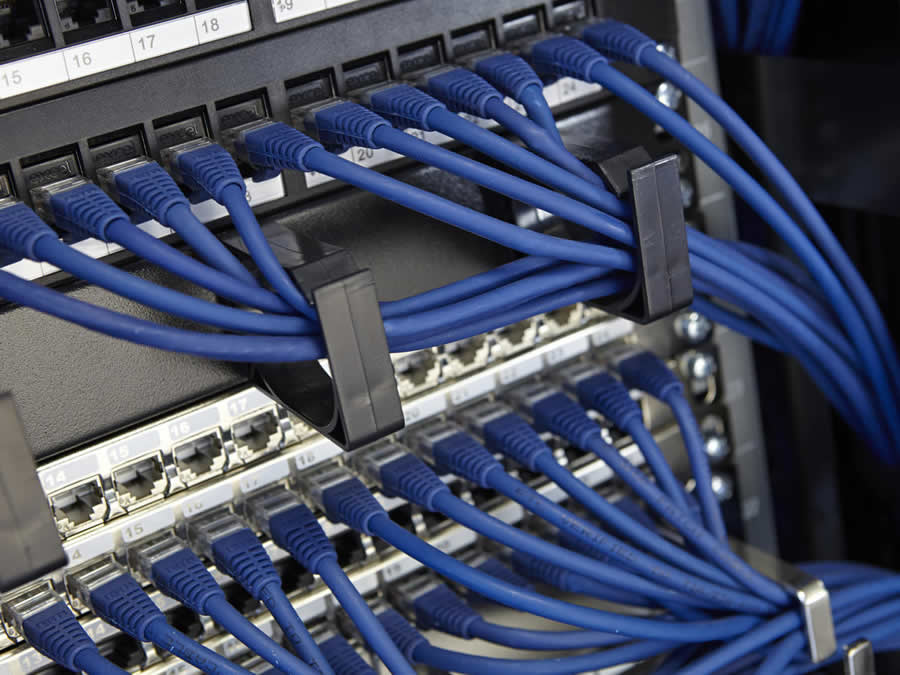 Network cable installer London fitting RJ45 data outlet neatly